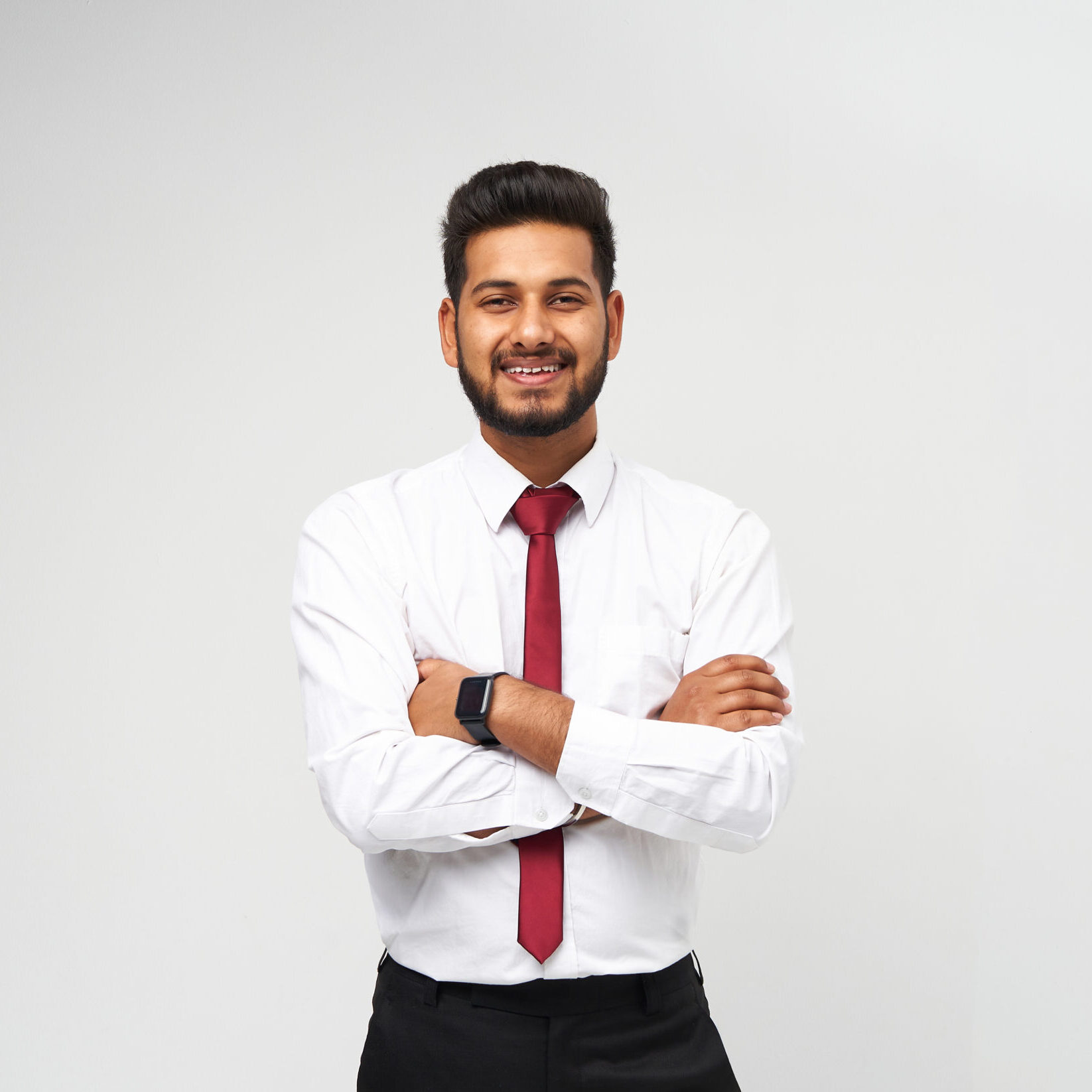 Portrait of young indian top manager in t-shirt and tie crossed arms and smiling on white isolated background